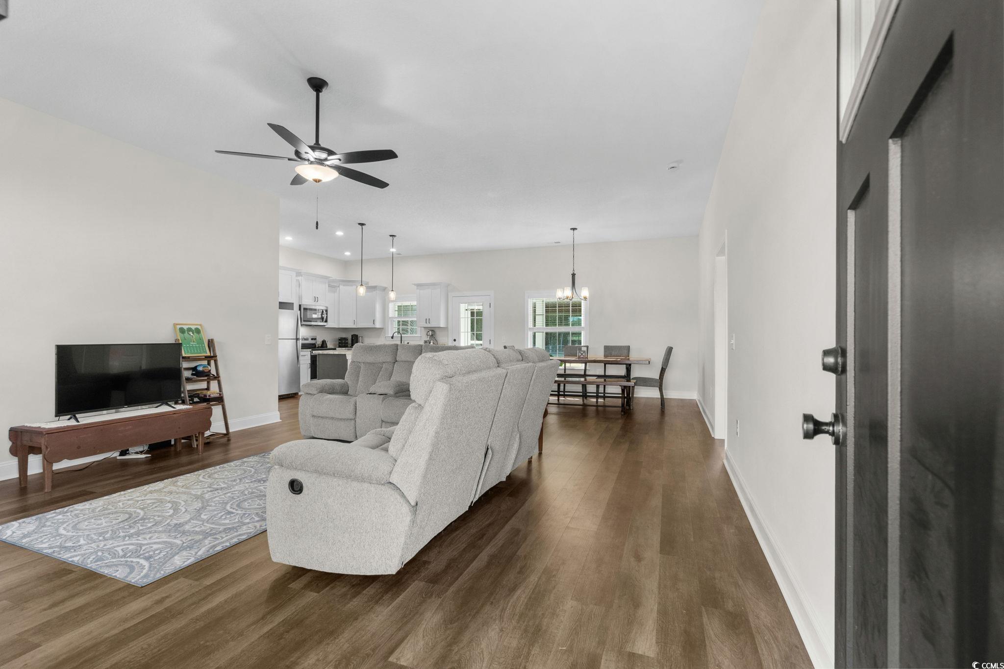 6782 Highway 366 Conway, SC 29526 - Photo 3 of 37 Living room featuring dark wood-style floors, a chandelier, and ceiling fan
