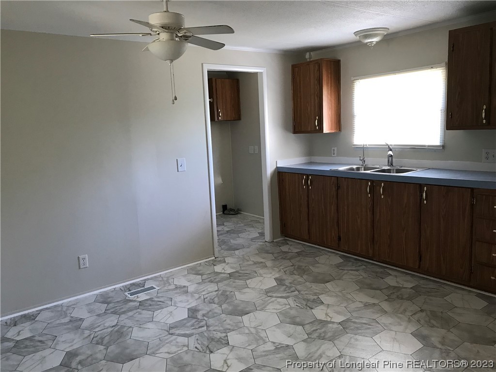 2046 Wade-Stedman Road Stedman, NC 28391 - Photo 12 of 17 a view of a kitchen with a sink and a window