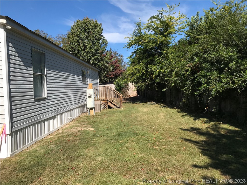 2046 Wade-Stedman Road Stedman, NC 28391 - Photo 15 of 17 a view of backyard with a table and chair and wooden fence