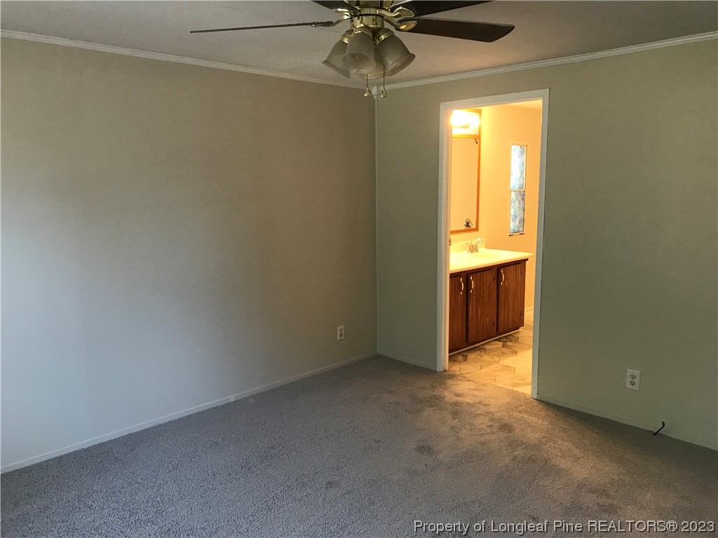 2046 Wade-Stedman Road Stedman, NC 28391 - Photo 3 of 17 an empty room with a ceiling fan and a window