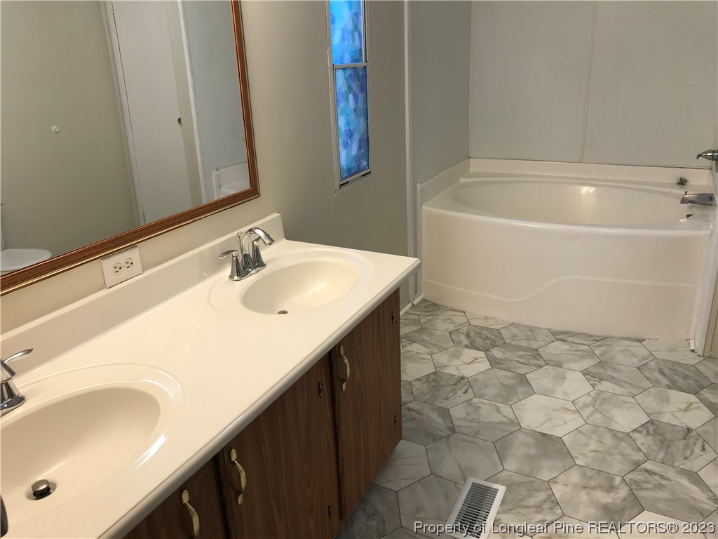 2046 Wade-Stedman Road Stedman, NC 28391 - Photo 4 of 17 a bathroom with a sink and a bathtub