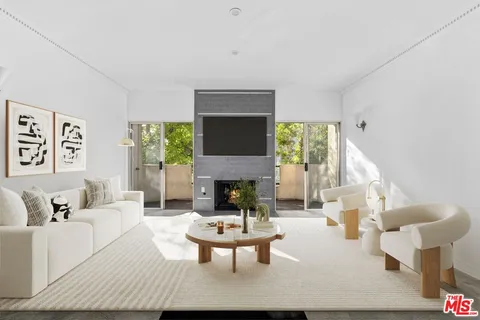 a living room with furniture a window and a fireplace
