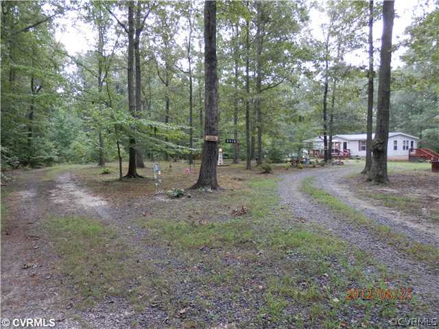 3415 Wickham Road Bumpass, VA 23024 - Photo 1 of 12 a view of a forest with trees in the background