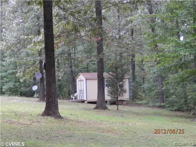 3415 Wickham Road Bumpass, VA 23024 - Photo 10 of 12 a backyard of a house with lots of green space