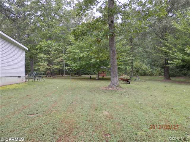 3415 Wickham Road Bumpass, VA 23024 - Photo 11 of 12 a view of a backyard with large trees