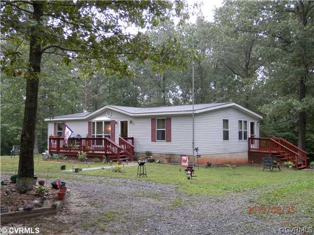 3415 Wickham Road Bumpass, VA 23024 - Photo 2 of 12 a front view of a house with garden