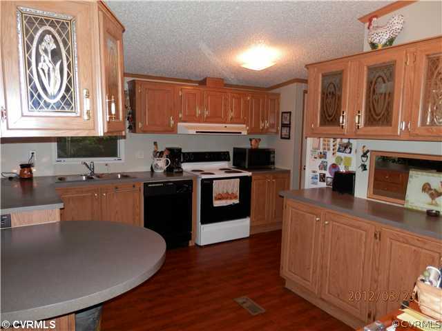 3415 Wickham Road Bumpass, VA 23024 - Photo 5 of 12 a kitchen with stainless steel appliances granite countertop a sink dishwasher stove top oven and cabinets