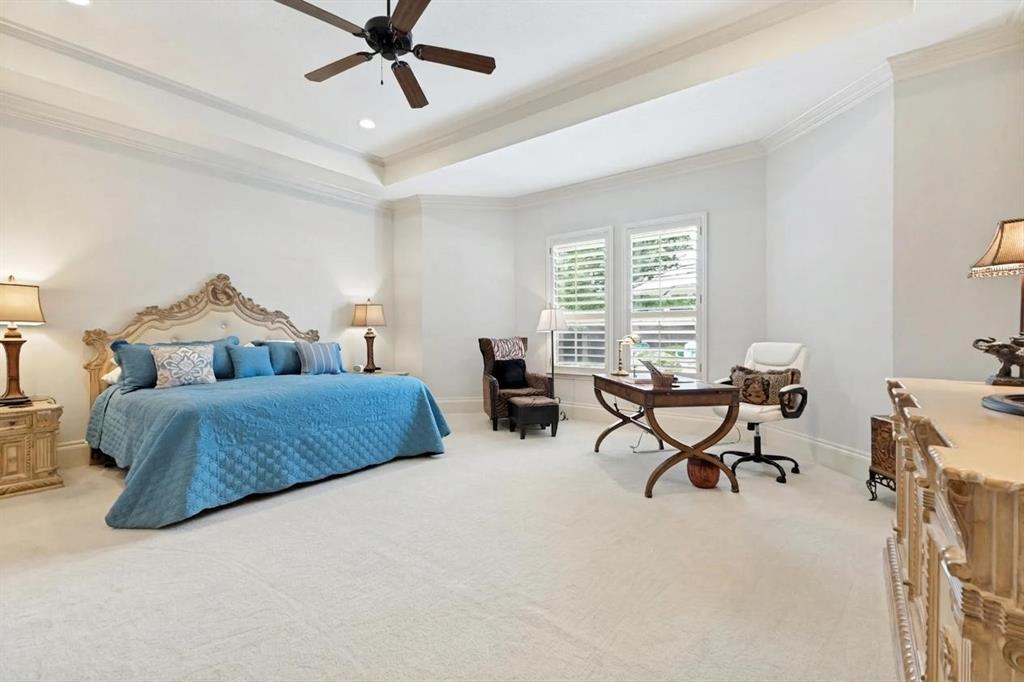 971 Elk Ridge Road Prosper, TX 75078 - Photo 13 of 29 Spacious Primary Bedroom featuring tray ceilings, crown molding, and incredible views of your backyard oasis!