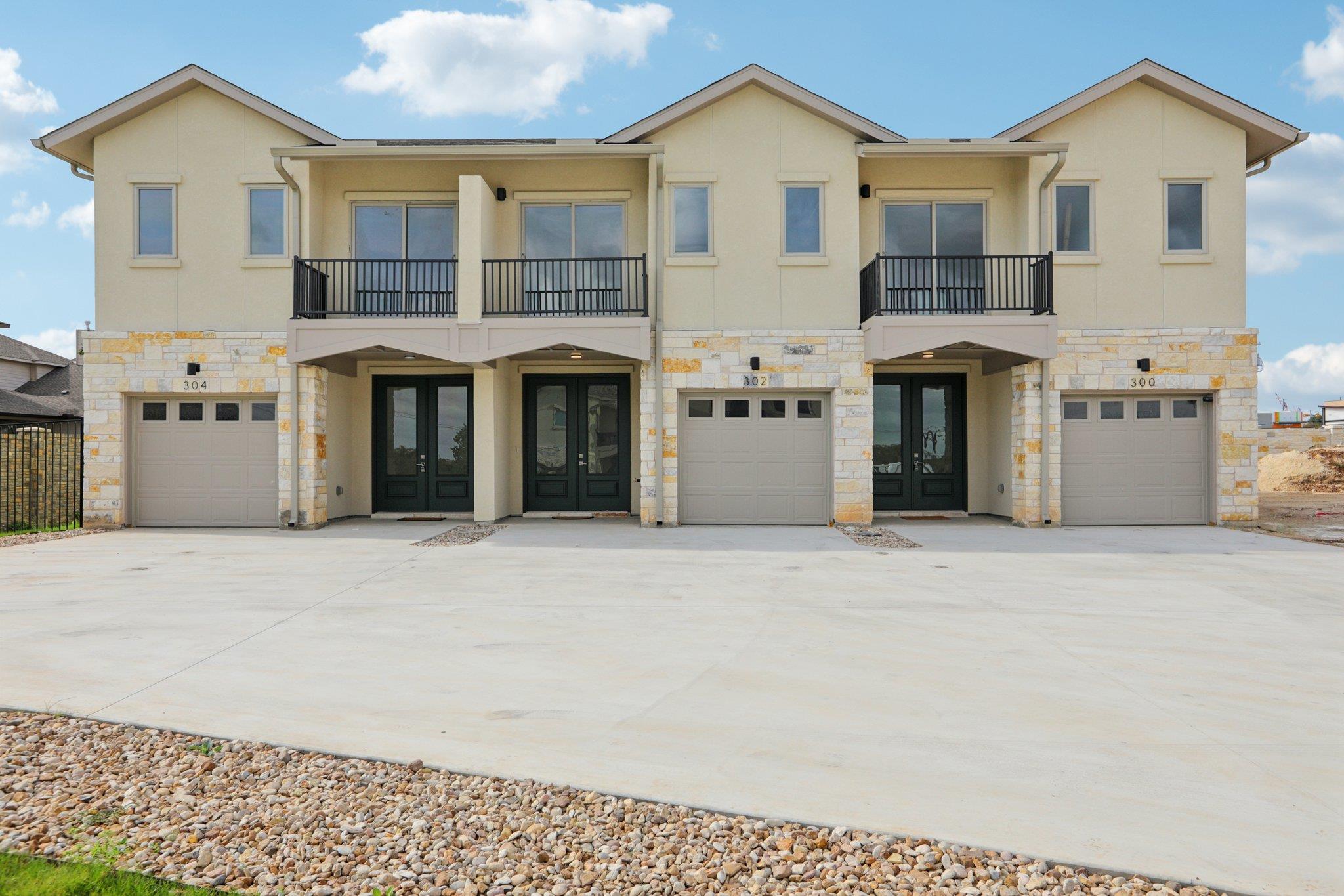 302 Tesla Circle Austin, TX 78681 - Photo 1 of 40 a front view of a house with a yard and garage