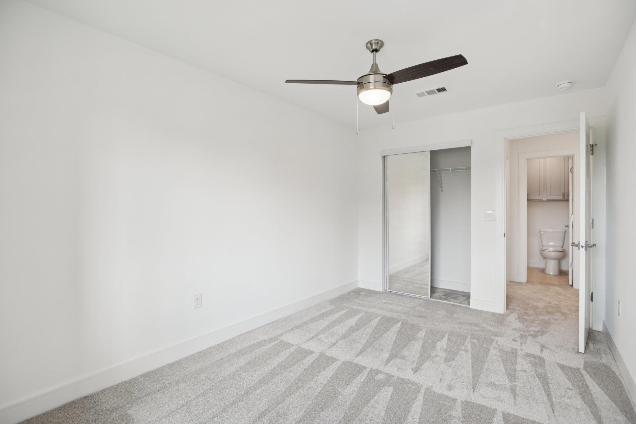 302 Tesla Circle Austin, TX 78681 - Photo 28 of 40 an empty room with closet and ceiling fan