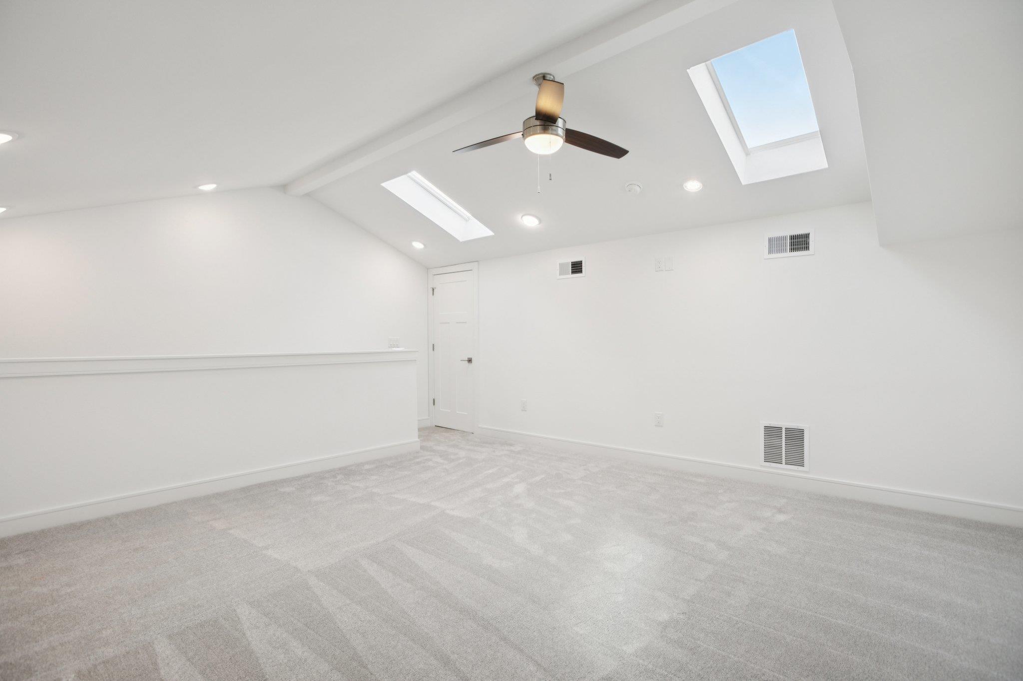 302 Tesla Circle Austin, TX 78681 - Photo 37 of 40 an empty room with projector and hardwood