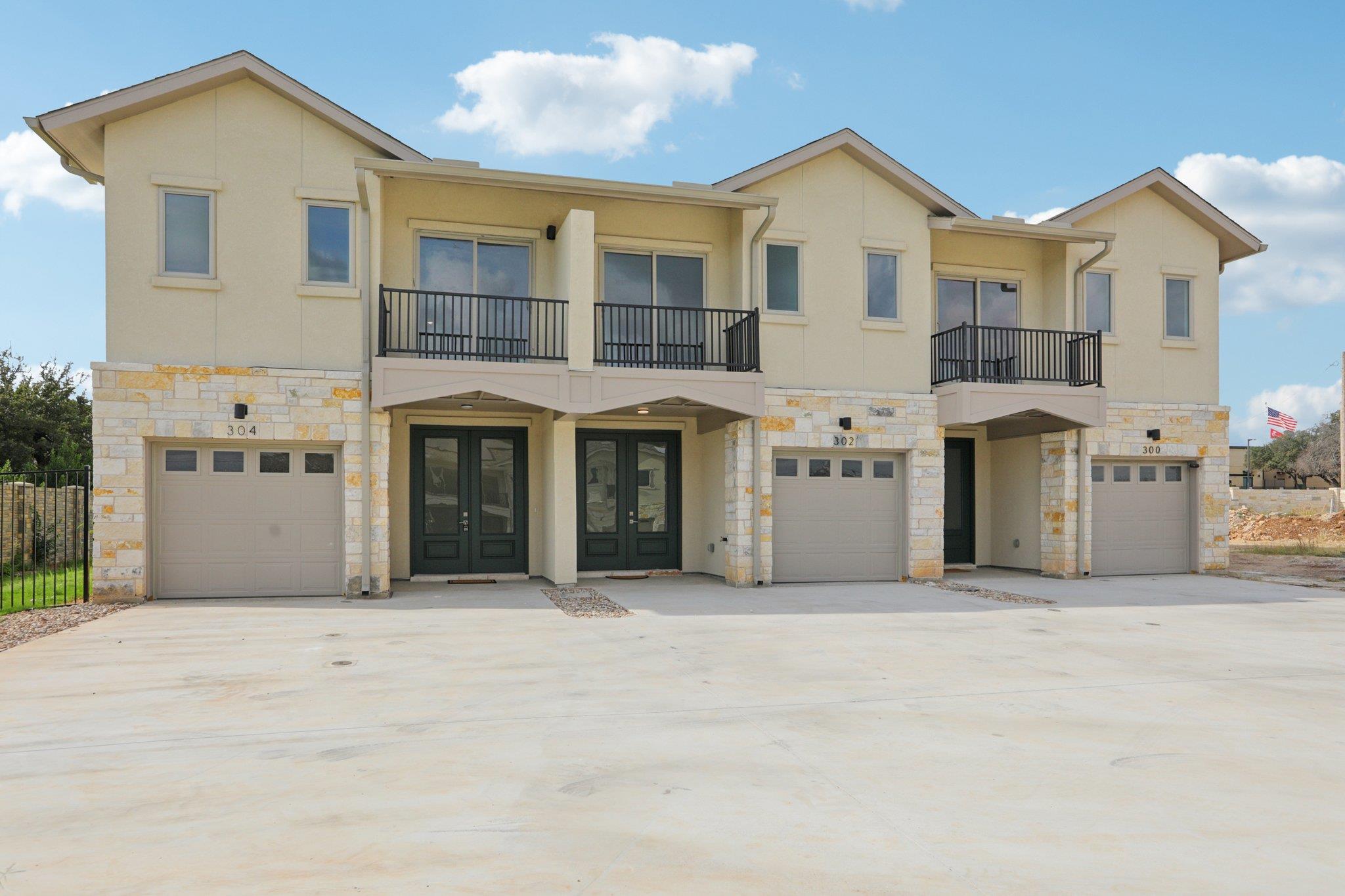 302 Tesla Circle Austin, TX 78681 - Photo 5 of 40 a view of a house with large windows and a yard