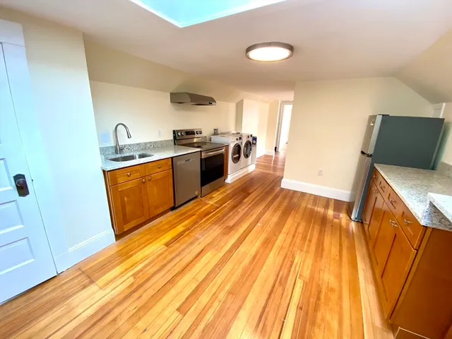 a kitchen with wooden floors and a sink
