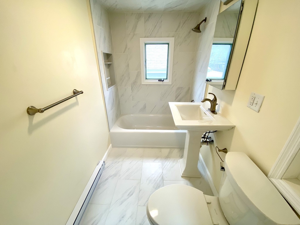 24 Clyde Road, Unit 3 Watertown, MA 02472 - Photo 11 of 13 a bathroom with a sink toilet and shower