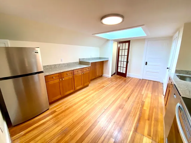 a view of a kitchen with wooden floor