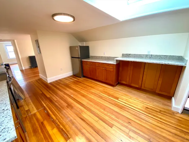 a view of a room with wooden floor