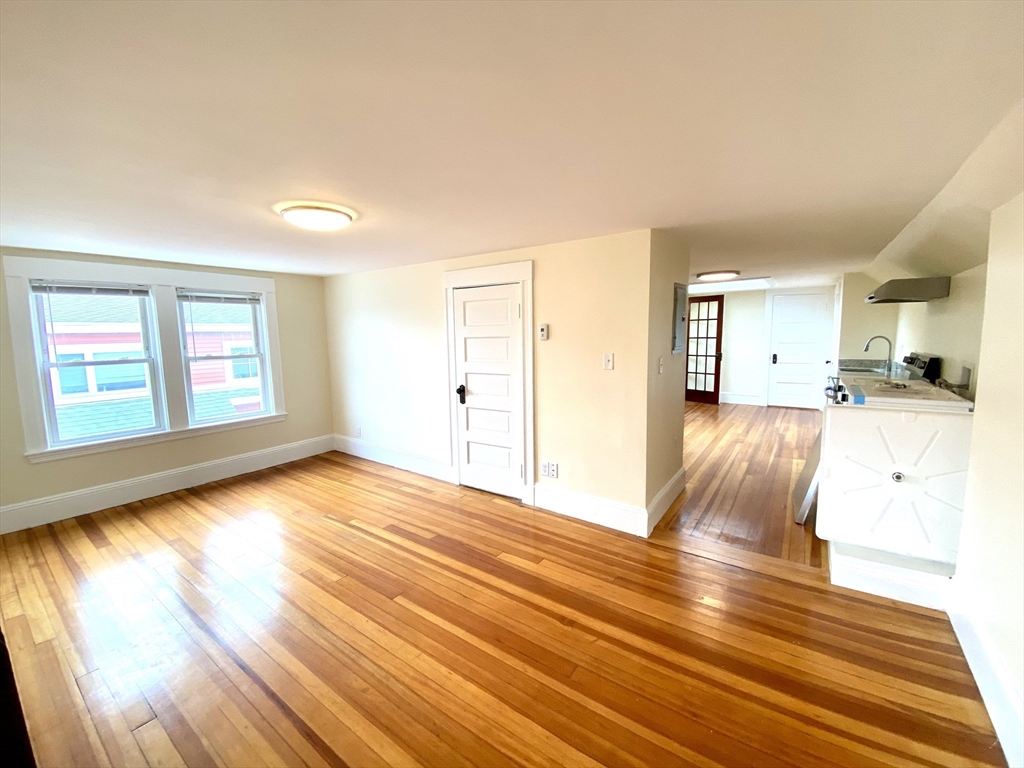 24 Clyde Road, Unit 3 Watertown, MA 02472 - Photo 5 of 13 a view of a livingroom with wooden floor