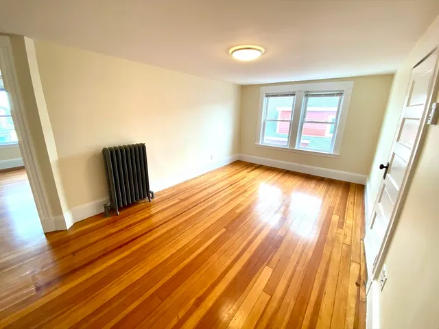a view of an empty room and wooden floor