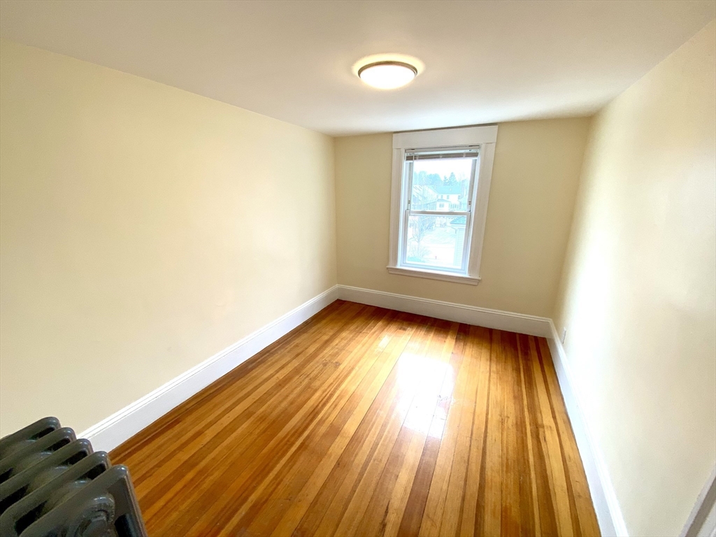 24 Clyde Road, Unit 3 Watertown, MA 02472 - Photo 8 of 13 a view of room with window and wooden floor