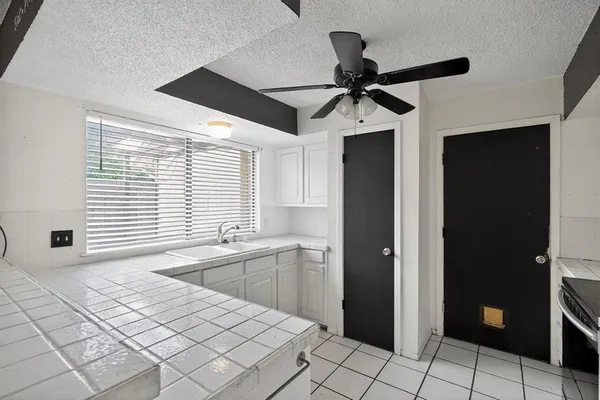 a kitchen with stainless steel appliances kitchen island granite countertop a refrigerator and a sink