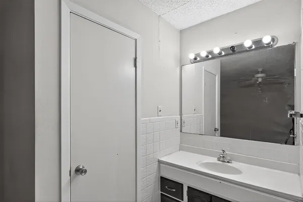 a bathroom with a sink vanity and a mirror