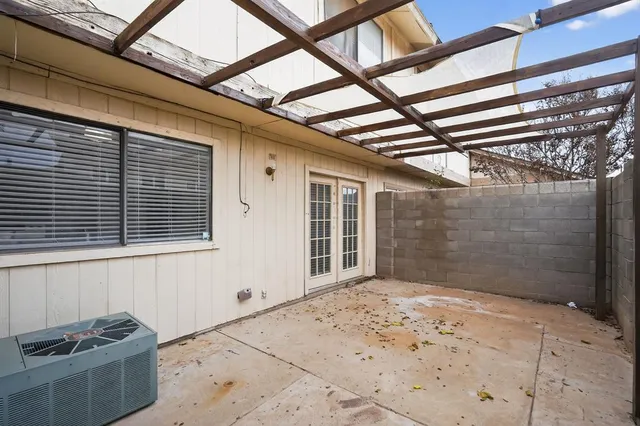 a view of a house with a yard and a large tree