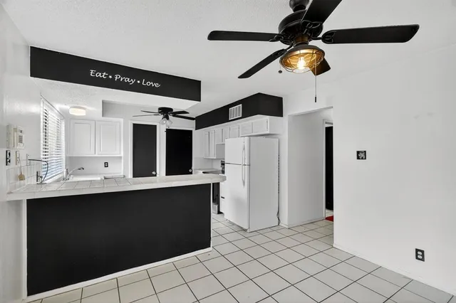 a kitchen with a sink stainless steel appliances and cabinets