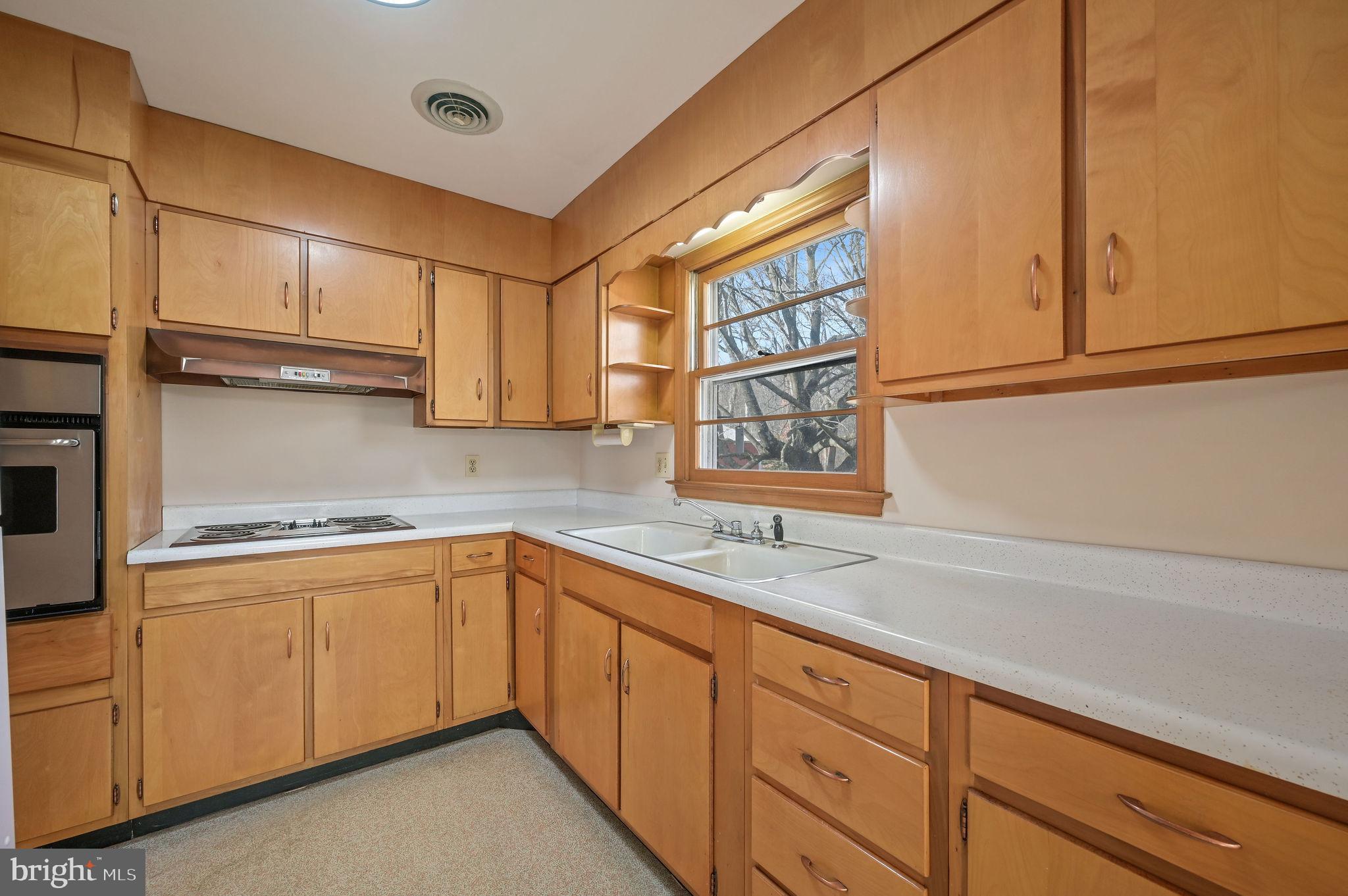 955 Twin Willows Road Smyrna, DE 19977 - Photo 11 of 27 a kitchen with stainless steel appliances granite countertop a sink and cabinets with wooden floor