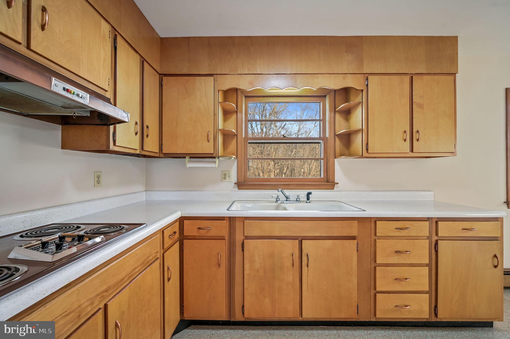 955 Twin Willows Road Smyrna, DE 19977 - Photo 12 of 27 a kitchen with stainless steel appliances granite countertop a sink a stove and a microwave
