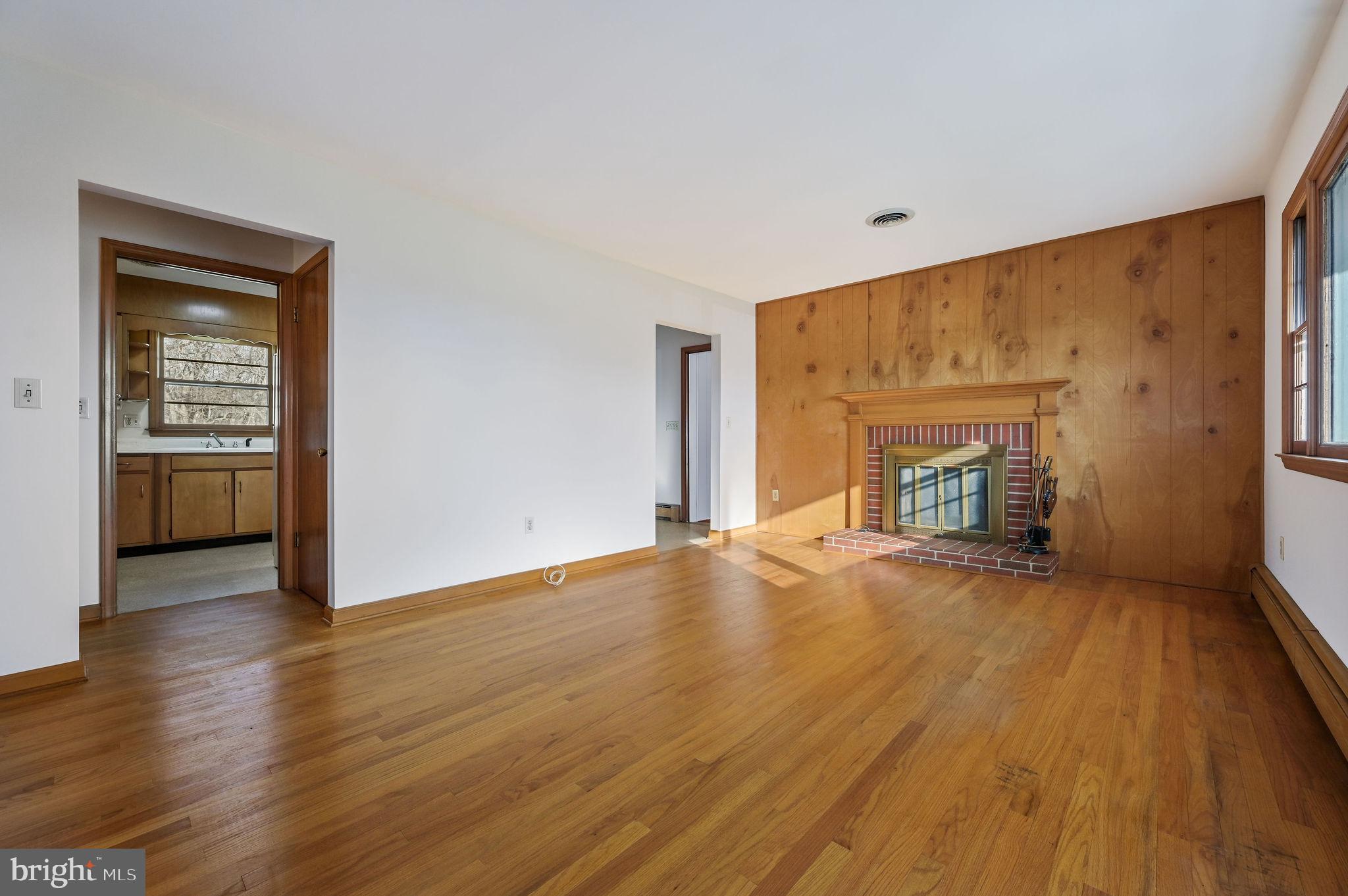 955 Twin Willows Road Smyrna, DE 19977 - Photo 15 of 27 a view of empty room with wooden floor and fireplace