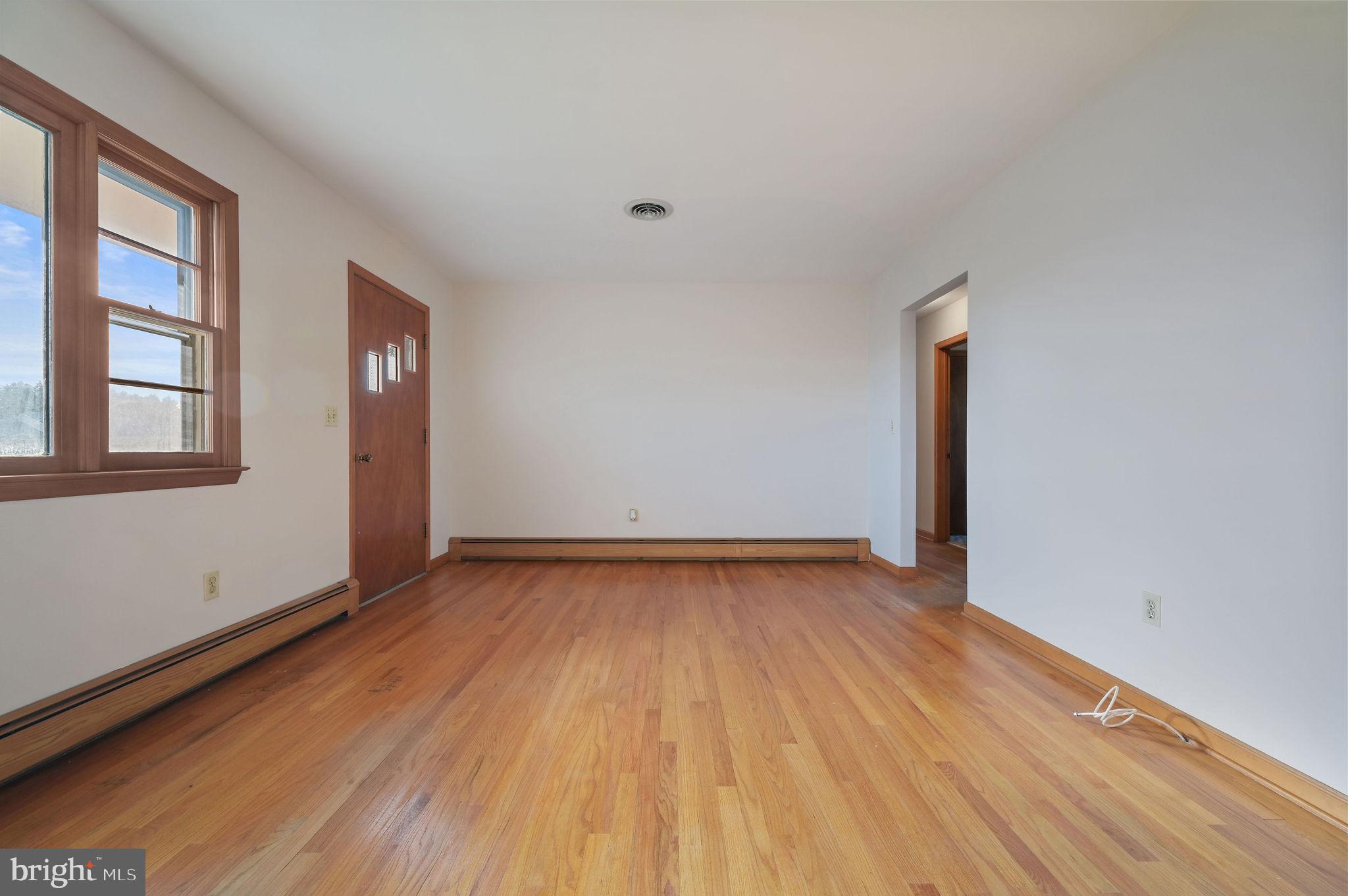 955 Twin Willows Road Smyrna, DE 19977 - Photo 16 of 27 an empty room with wooden floor and windows