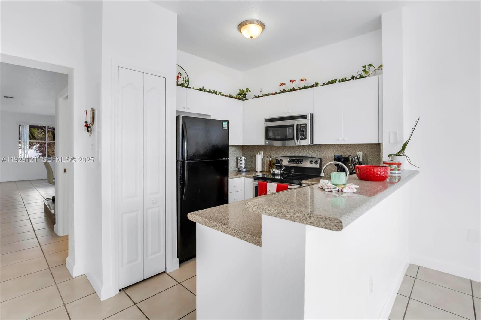 17710 Northwest 73rd Avenue, Unit 20120 Hialeah, FL 33015 - Photo 15 of 39 a kitchen with stainless steel appliances granite countertop a refrigerator and a sink