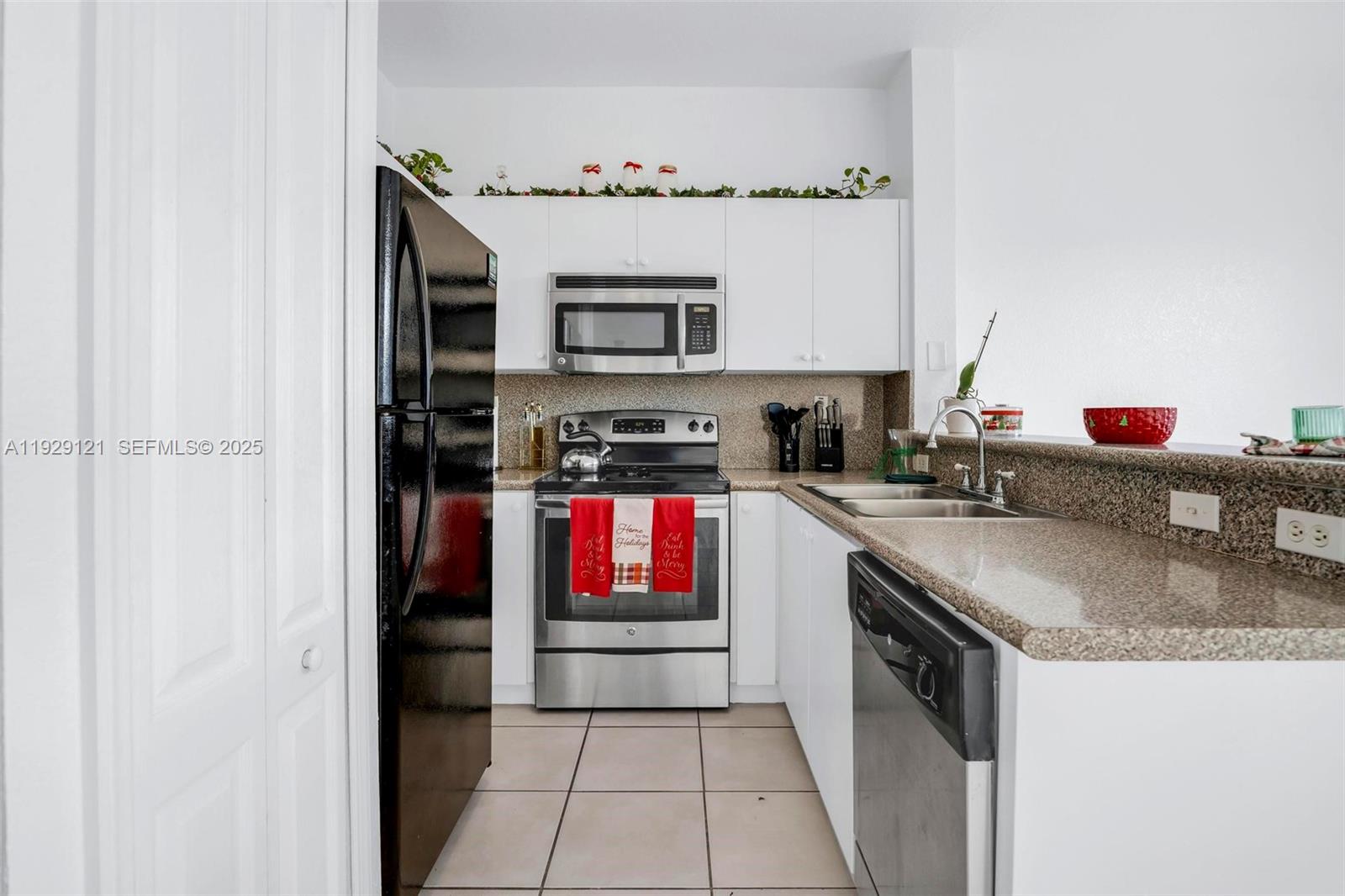 17710 Northwest 73rd Avenue, Unit 20120 Hialeah, FL 33015 - Photo 18 of 39 a kitchen with stainless steel appliances granite countertop a stove and a sink