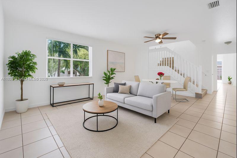 17710 Northwest 73rd Avenue, Unit 20120 Hialeah, FL 33015 - Photo 2 of 39 a living room with furniture a window and a potted plant