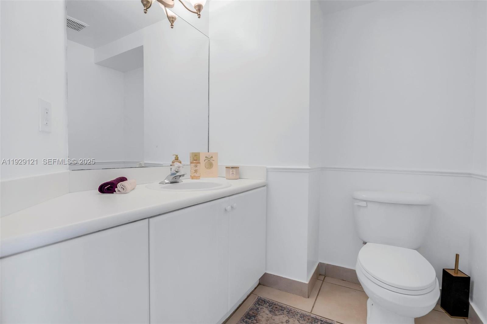 17710 Northwest 73rd Avenue, Unit 20120 Hialeah, FL 33015 - Photo 21 of 39 a bathroom with a sink toilet and vanity