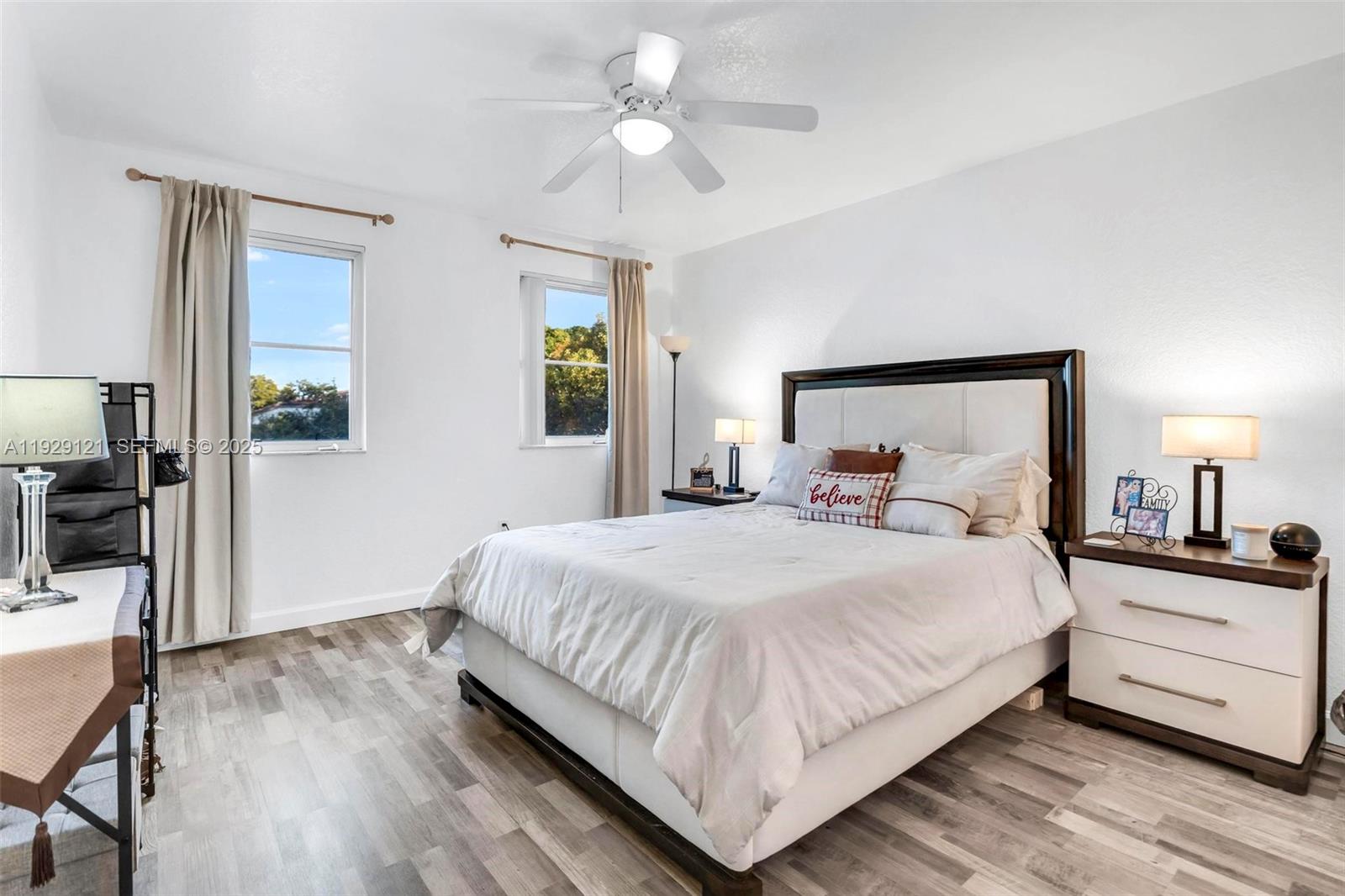 17710 Northwest 73rd Avenue, Unit 20120 Hialeah, FL 33015 - Photo 22 of 39 a bedroom with a bed and wooden floor