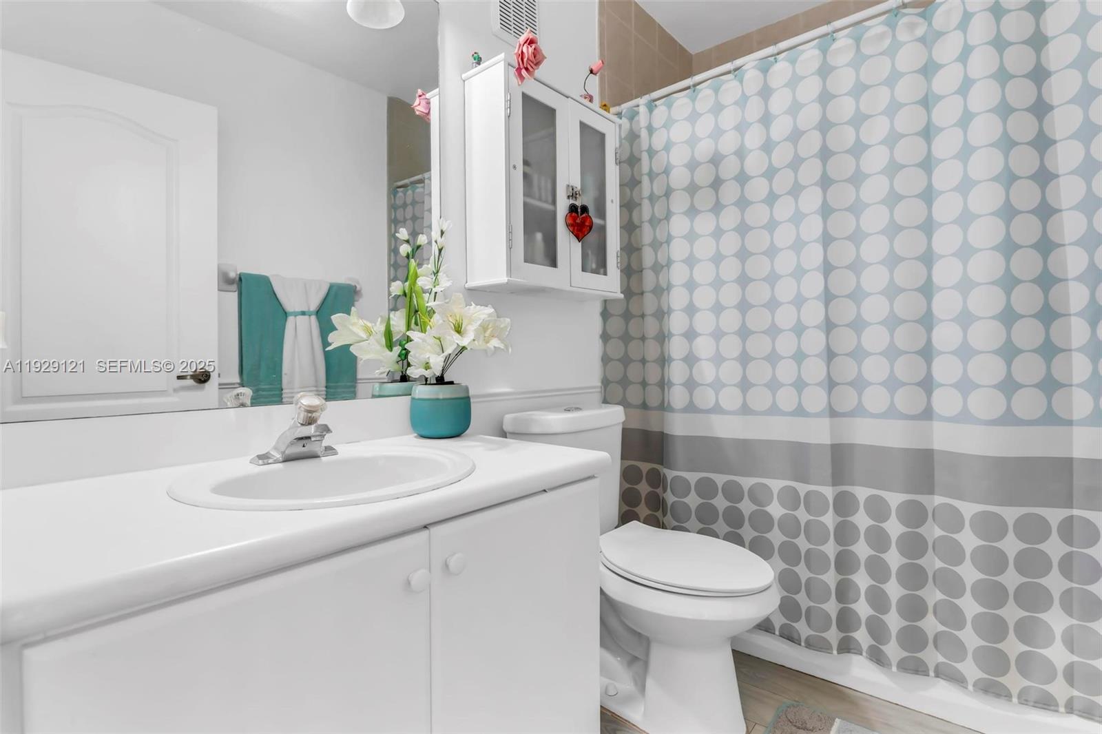 17710 Northwest 73rd Avenue, Unit 20120 Hialeah, FL 33015 - Photo 26 of 39 a bathroom with a sink a toilet and mirror