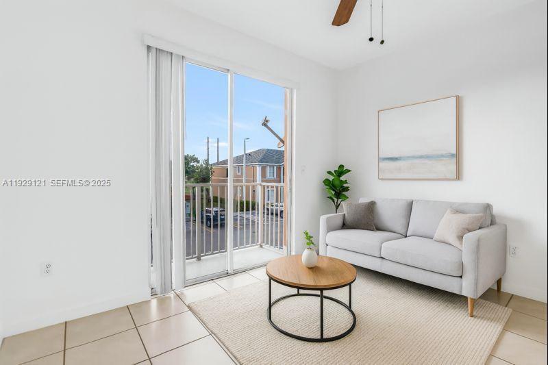 17710 Northwest 73rd Avenue, Unit 20120 Hialeah, FL 33015 - Photo 4 of 39 a living room with furniture a glass door and a rug