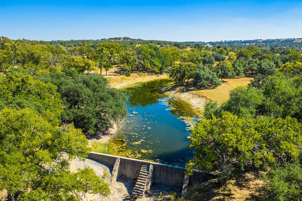 1495 Walnut Springs Road, Unit 68 Johnson City, TX 78636 - Photo 16 of 23 a view of a lake with a mountain in the background
