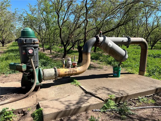 an outdoor space with seating area and trees around