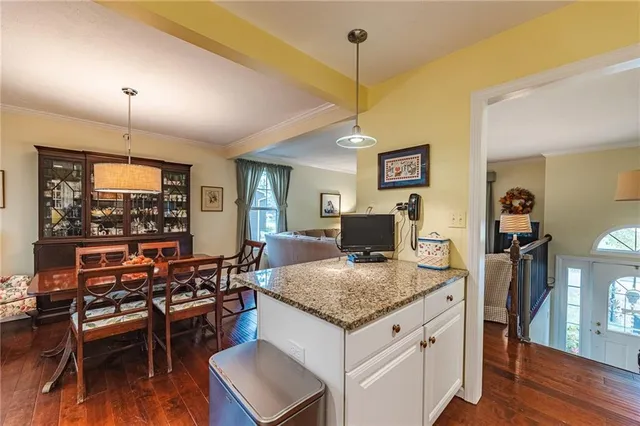 a view of living room with granite countertop furniture and wooden floor