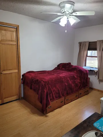 a bedroom with a bed and a chandelier