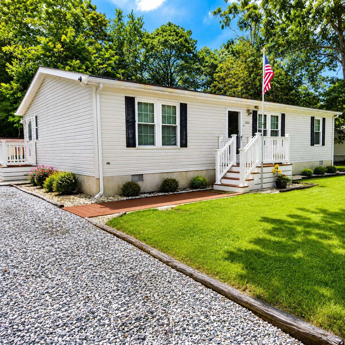 24212 Durham Street Georgetown, DE 19947 - Photo 1 of 21 Front view of charming home with lush greenery