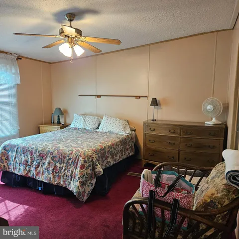 a bedroom with a bed and chandelier