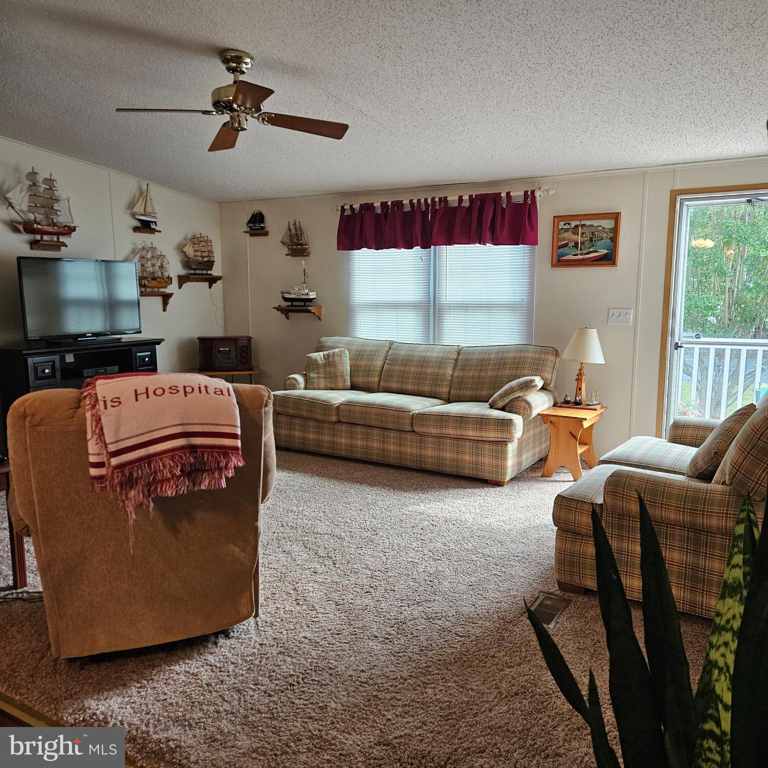 24212 Durham Street Georgetown, DE 19947 - Photo 6 of 21 a living room with furniture ceiling fan and a window