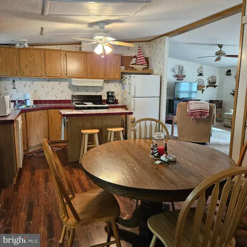 a kitchen with a table chairs and a refrigerator
