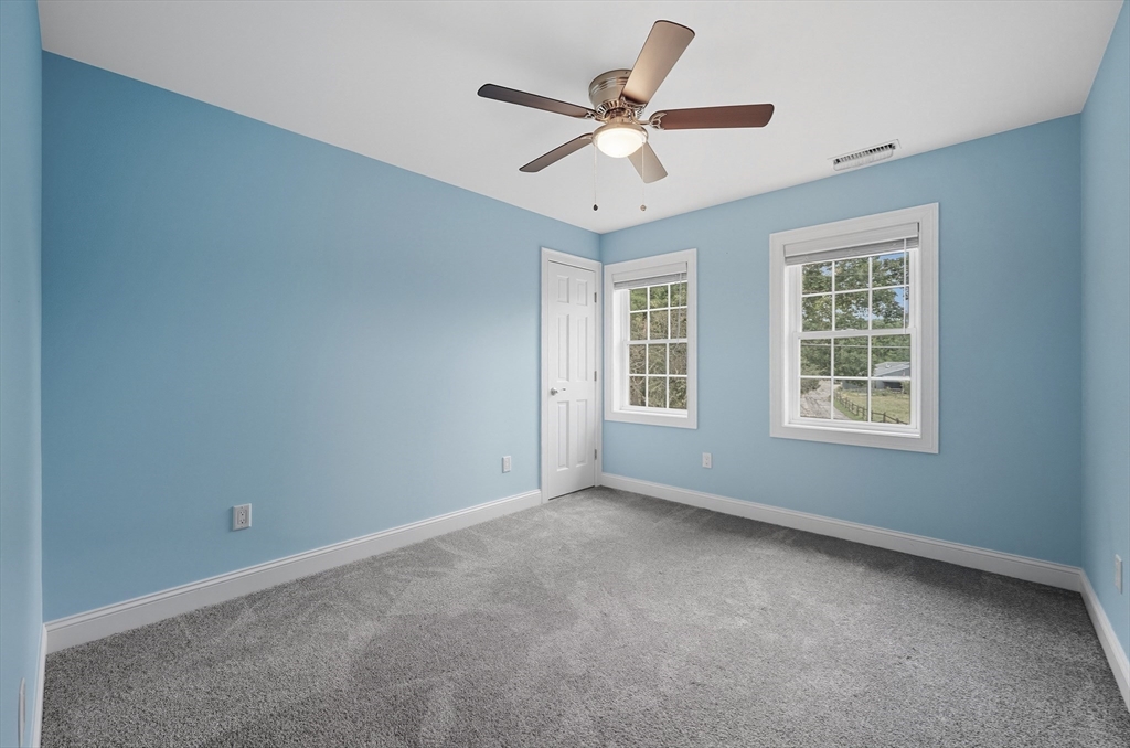 40 East Street Topsfield, MA 01983 - Photo 18 of 39 an empty room with ceiling fan and windows