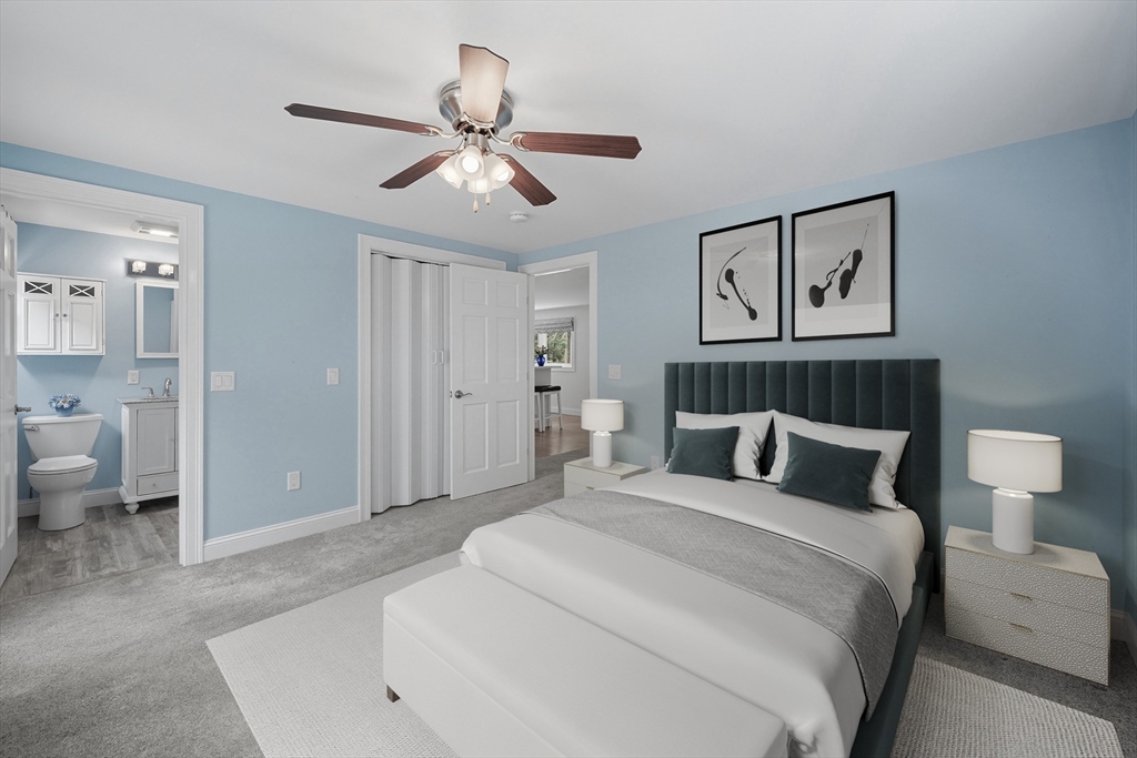 40 East Street Topsfield, MA 01983 - Photo 28 of 39 a spacious bedroom with a bed and a lamp