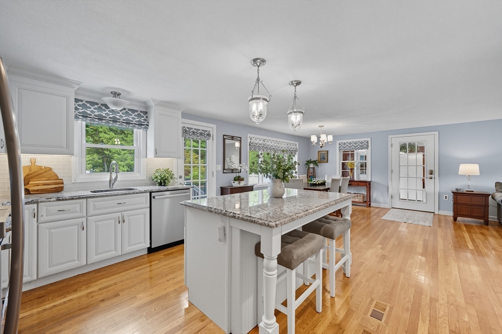 40 East Street Topsfield, MA 01983 - Photo 7 of 39 a kitchen with granite countertop a sink cabinets and wooden floor