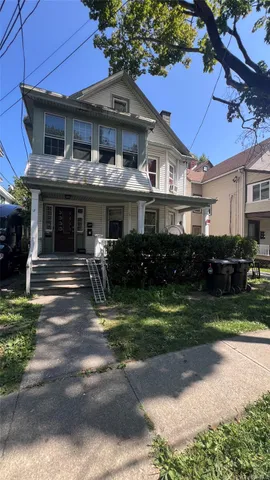 a front view of a house with a yard table and chairs